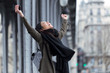 © nenetus - Excited asian young woman celebrating a success in the street.
