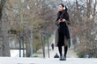 © nenetus - Pretty asian young woman listening to music with her smartphone in the street.