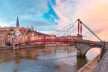 Fototapete - Saint Georges church and footbridge across Saone river, Old town with Fourviere cathedral at gorgeous sunset in Lyon, France