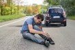 © vchalup - Hit and run concept. Injured man on road in front of a car.