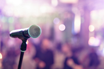 Close up microphone on stage in concert hall restaurant or conference room. Blurred background. Copy space