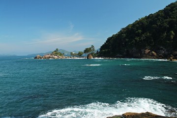 Wall Mural - Costeira de Ubatuba, Sao Paulo, Brazil - Paradise tropical beach with white sand, blue and calm waters, without people on a sunny day and blue sky of the Brazilian coast in high resolution