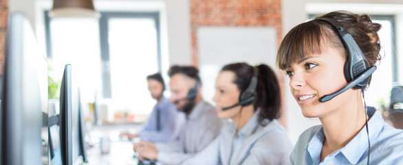 Wall Mural - Call center worker accompanied by her team.