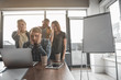 © Yakobchuk Olena - Men and women staring at laptop monitor in meeting room. Their expressions are frustrated. Copy space in right side