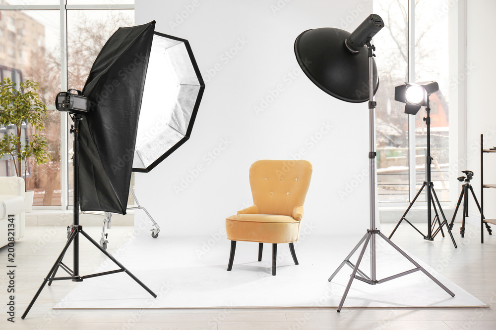 Armchair in photo studio with professional equipment - obrazy, fototapety, plakaty 