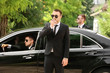 © Africa Studio - Handsome bodyguards near car outdoors