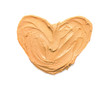 Heart made of peanut butter on white background