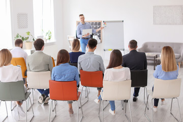 Wall Mural - Male business trainer giving lecture in office