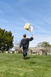 Graduate Tossing Book in the Air