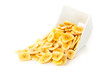 Heap of dried banana chips snack in white bowl over white