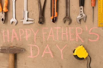 Happy father's day . Various tools on the cement floor