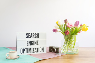 Wall Mural - Light box with search engine optimization writing on wooden desk with white background
