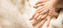 Newborn Child Hand. Closeup Of Baby Hand Into Parents Hands. Family, Maternity And Birth Concept. Banner
