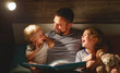 © JenkoAtaman - evening family reading. father reads children . book before going to bed