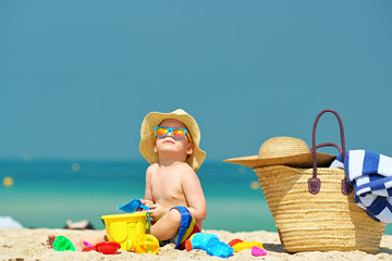 Wall Mural - Two year old toddler playing on beach