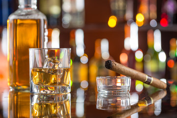 Whiskey drinks on bar counter.