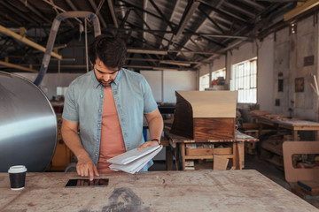 Wall Mural - Young artisan coming up with new designs in his workshop