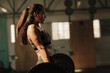 © Jacob Lund - Physically fit woman lifting heavy weights