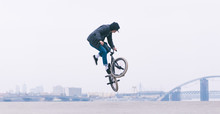 BMX Rider Makes A TAilwhip Trick. Young Man Doing Tricks In The Air On A BMX Bike. BMX Freestyle