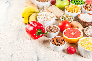 Wall Mural - Diet food background concept, healthy carbohydrates (carbs) products - fruits, vegetables, cereals, nuts, beans, light concrete background copy space