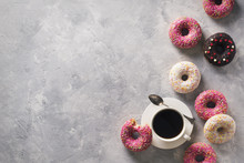 Sone Pink And White Donuts With Cup Of Coffee Over Grey Stone Texture