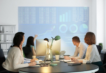 Wall Mural - Office employees watching presentation during meeting. Forex concept