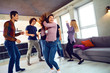 © Studio Romantic - Friends dance fun at a student's party in the apartment.