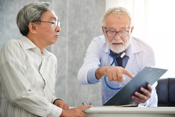 Wall Mural - Senior male Doctor is discussing with male patient.