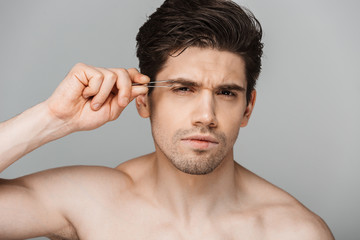 Wall Mural - Close up beauty portrait of half naked concentrated young man