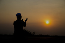 Silhouette Young Asian Muslim Man Praying On Sunset,Ramadan Festival Concept