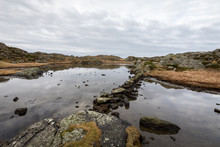 Pond By The Trail, At The Rovaer Archipelago, Island In Haugesund, Norway. Stones Making A Path Through The Water.