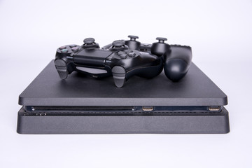 two controllers lying on the game console. White background