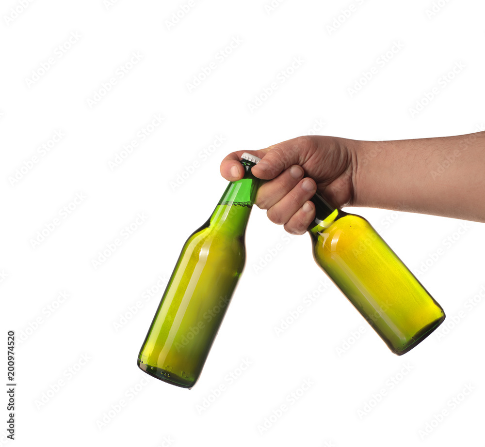 dwie butelki piwa w dłoni - obrazy, fototapety, plakaty 