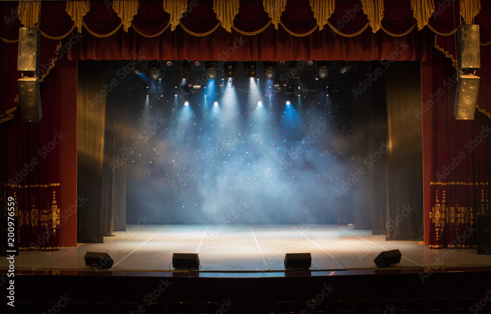 The stage of the theater illuminated by spotlights from the auditorium - obrazy, fototapety, plakaty 