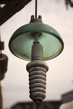 Isolated View Of Vintage Porcelain And Green Glass Insulator Against Out Of Focus Background