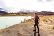 © jpbarcelos - woman looking toward awesome view of Torres del Paine mountain range