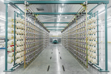 Wall Mural - textile yarn on the warping machine. machinery and equipment in a textile factory