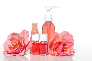 Wall Mural - Rose extract. Cosmetics set with rose extract.Serum in  ampoules, tonic and gel for face skin, flowers of roses on white background.