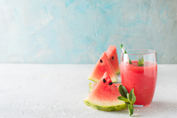 Wall Mural - Watermelon smoothie with slice of fruit and leaf of mint