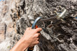 © anzebizjan - Closeup of female climber attaching via ferrata set to steel cable.