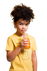 Wall Mural - Cute little boy drinking orange juice with a straw