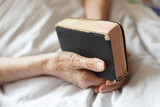 Fototapeta  - Hands of a senior woman on cane. Senior lying in a bed.
