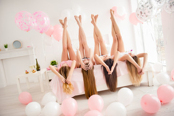 Canvas Print - Portrait of charming, pretty, attractive, slim, stylish, slender girls lying head over heels on bed with raised crossed legs and hands, celebrating birthday, holiday, event