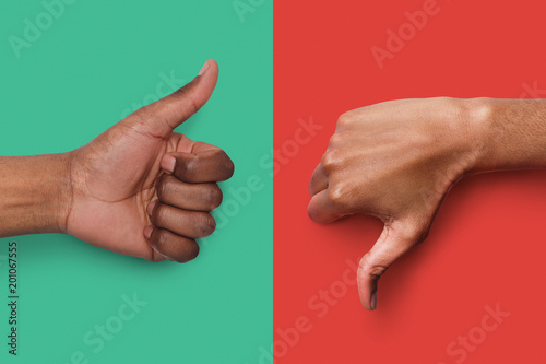 Fotografía Black hands with thumb up and down gestures