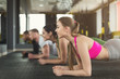 © Prostock-studio - Fitness group plank training indoors