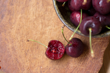 Canvas Print - Bowl of Cherries. Red cherries in a bowl on wooden background