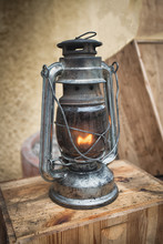 Old Fashioned Lantern On The Wooden Table. Vintage Style Metal Lamp Outdoor.