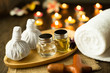 © chompoo - Selective focus Herbal compress balls with oil, towel, Massage wood on the wooden table in spa salon.  alternative medicine and relaxation Concept.