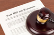 © wirojsid - Last will and testament on yellowish paper with wooden judge gavel; document is mock-up