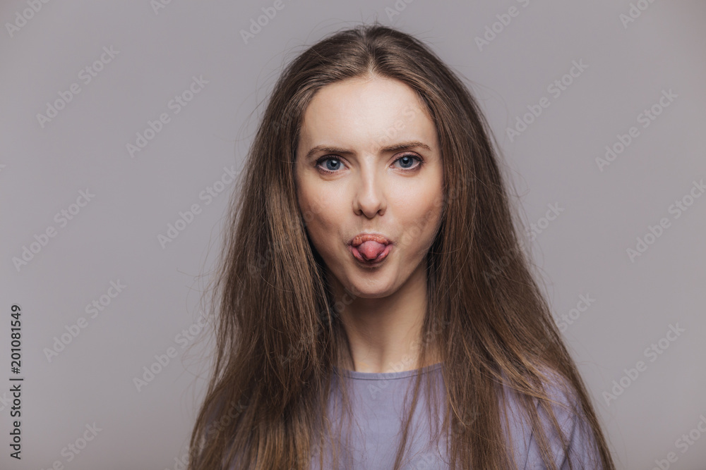 Funny Brunette Female With Atractive Look Shows Tongue